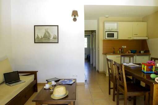 Living room and kitchenette of an apartment of the holiday residence Goélia Cap Bleu in Carro