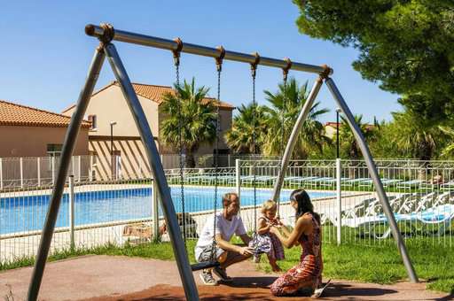 Swing next to the outdoor pool of the Goélia Cap Bleu holiday residence in Carro