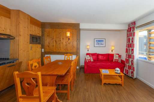 Example of a living room and kitchenette in a flat at the Goélia Le Sornin holiday residence in Autrans en Vercors in Isère.