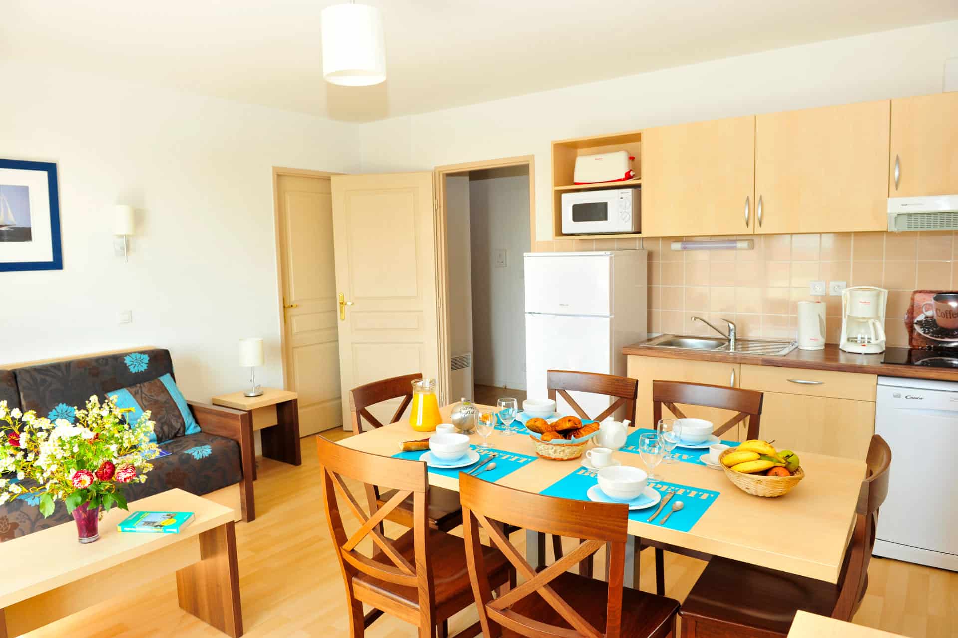Salon avec kitchenette d'un appartement de la résidence de vacances Goélia La Grande Plage à St-Gilles-Croix-de-Vie Salon avec kitchenette d'un appartement de la résidence de vacances Goélia La Grande Plage à St-Gilles-Croix-de-Vie