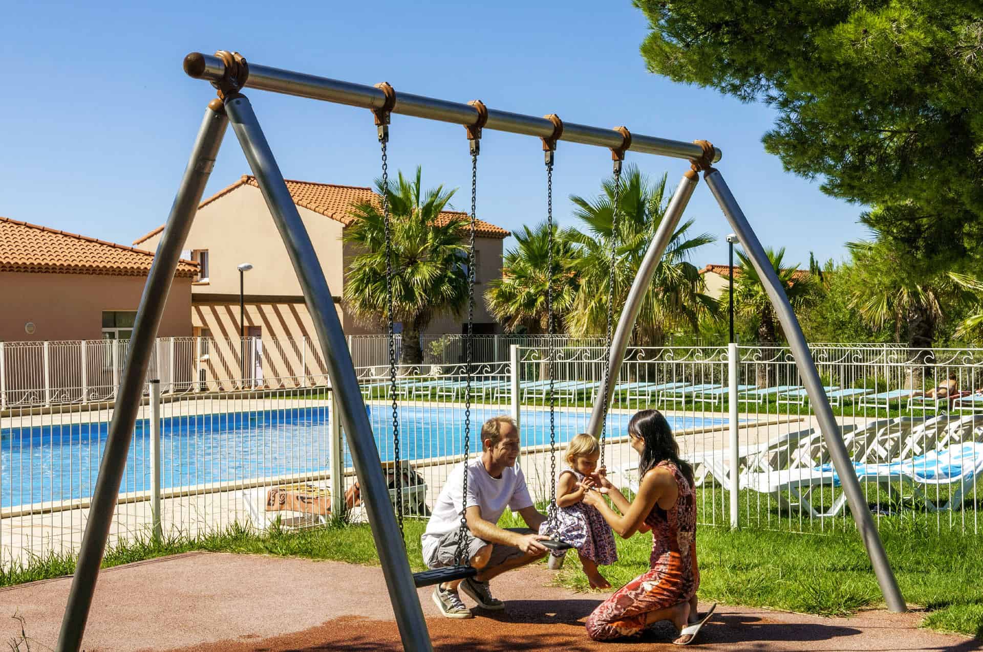 Swing next to the outdoor pool of the Goélia Cap Bleu holiday residence in Carro Swing next to the outdoor pool of the Goélia Cap Bleu holiday residence in Carro