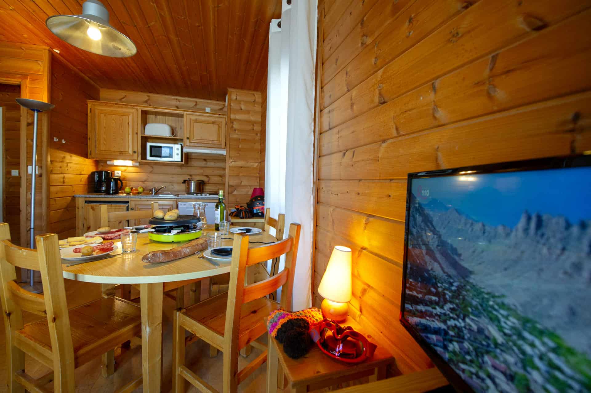 Living room with fully equipped kitchen in the Goélia Les Chalets des Marmottes vacation residence in St Jean d'Arves Living room with fully equipped kitchen in the Goélia Les Chalets des Marmottes vacation residence in St Jean d'Arves