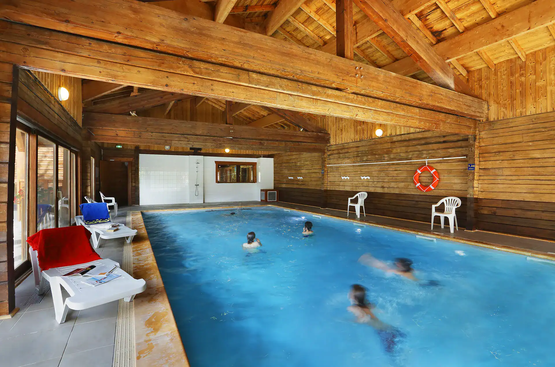 Heated indoor swimming pool at the Goélia Les Chalets du Bois de Champelle holiday residence in M