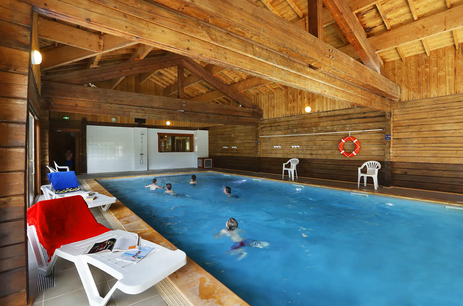 Heated indoor swimming pool at the Goélia Les Chalets du Bois de Champelle holiday residence in M