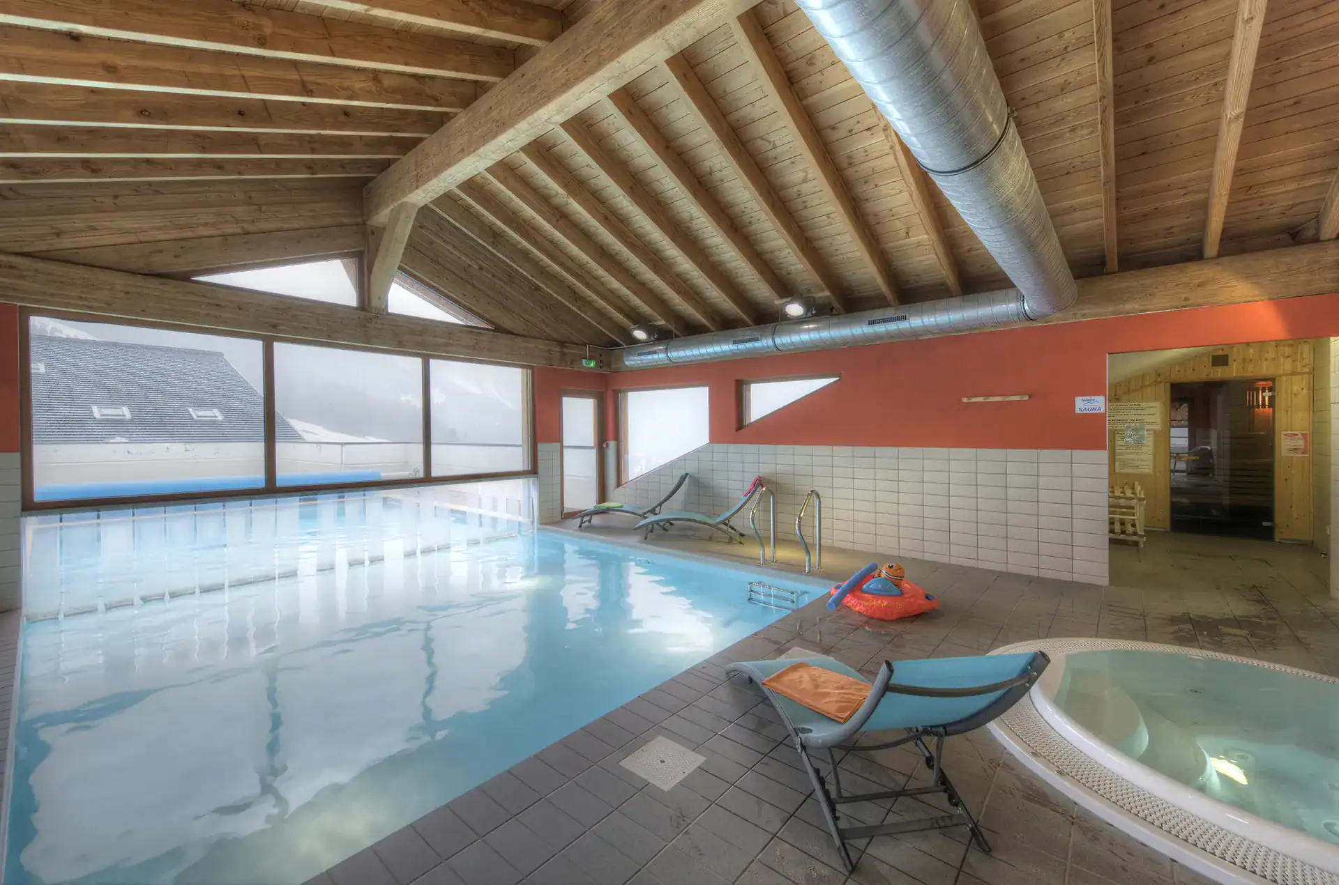 Heated indoor/outdoor swimming pool at the Goélia Le Grand Lodge holiday residence in Châtel with hot tub